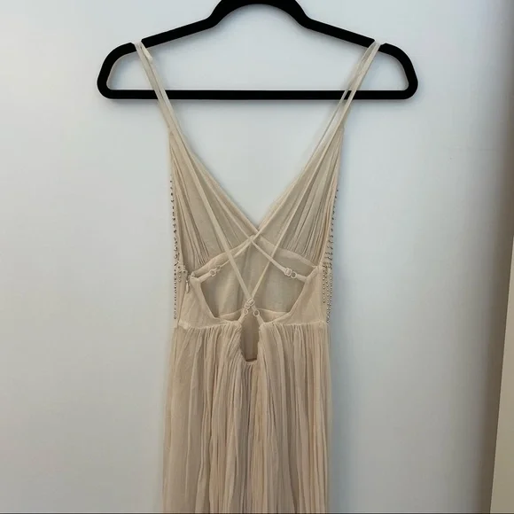 Free People Cream sparkly mini dress with a strappy back!
Size: 2 Never worn! - Picture 2 of 4